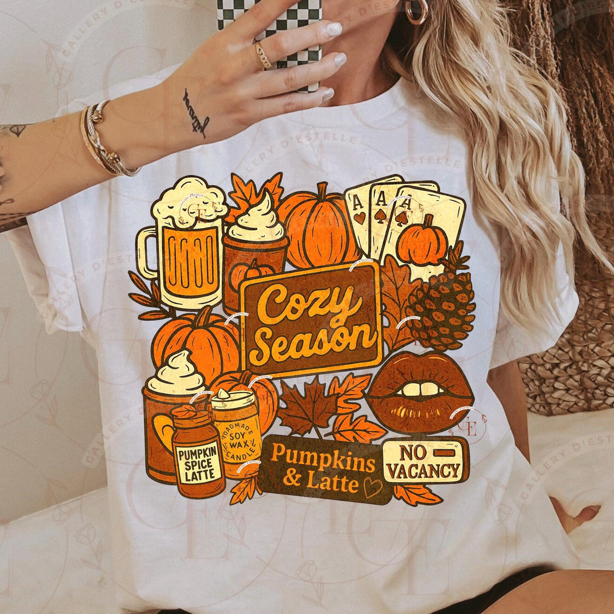 Person wearing a white t-shirt with autumn-themed graphics and text.