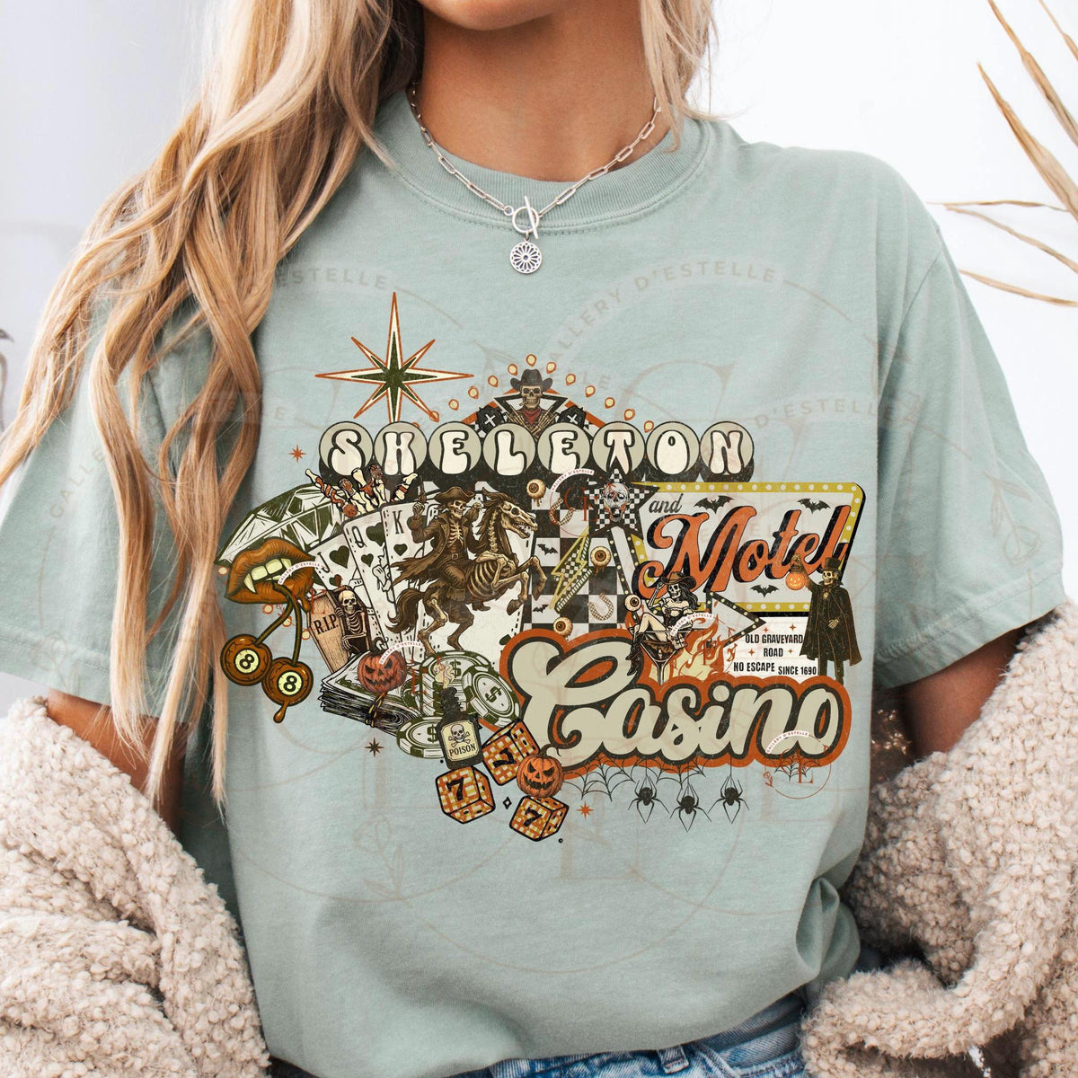 Person wearing a light blue t-shirt with a 'Skeleton Motel Casino' graphic design.