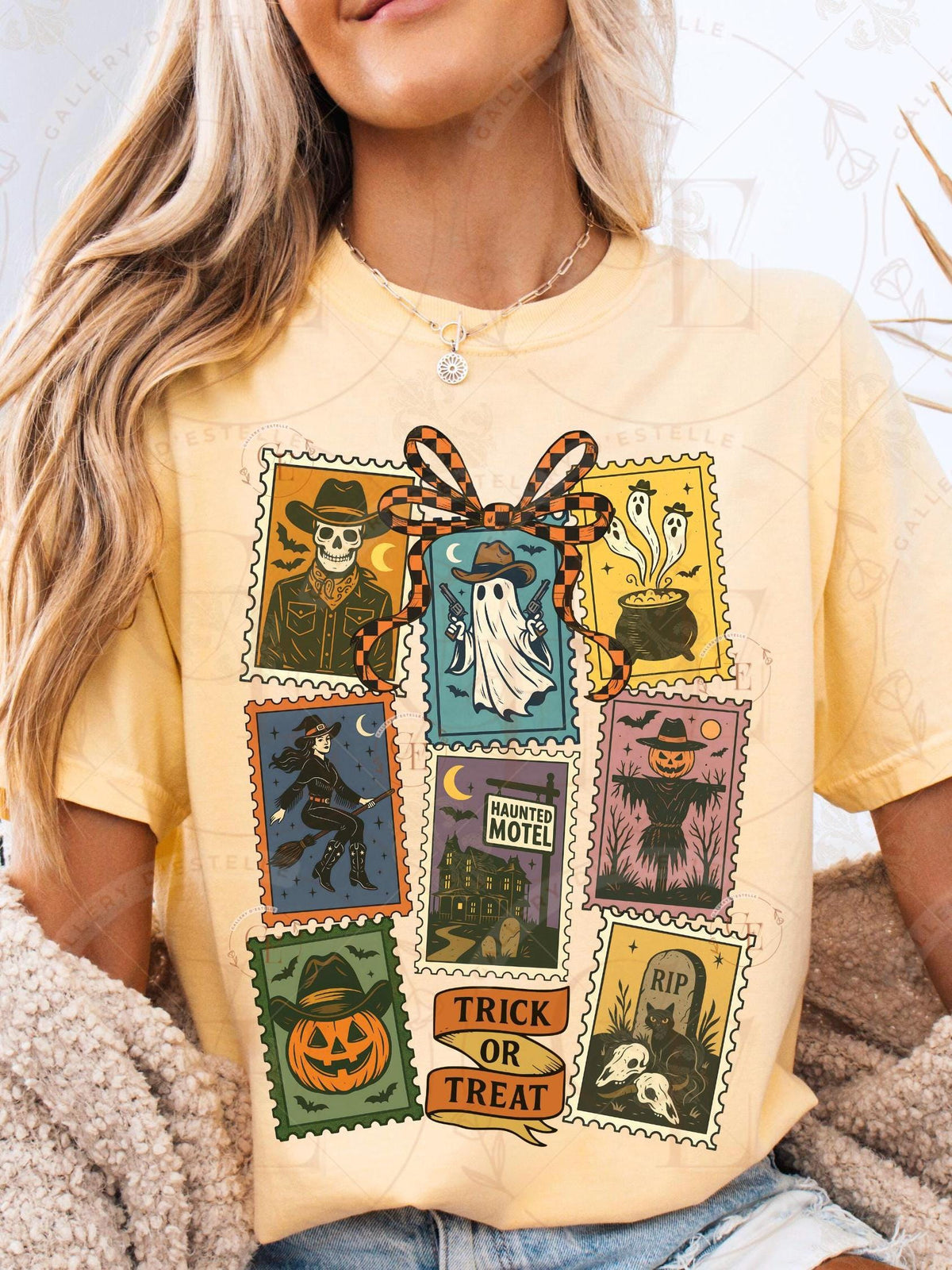 Person wearing a yellow t-shirt with Halloween-themed postage stamp design.