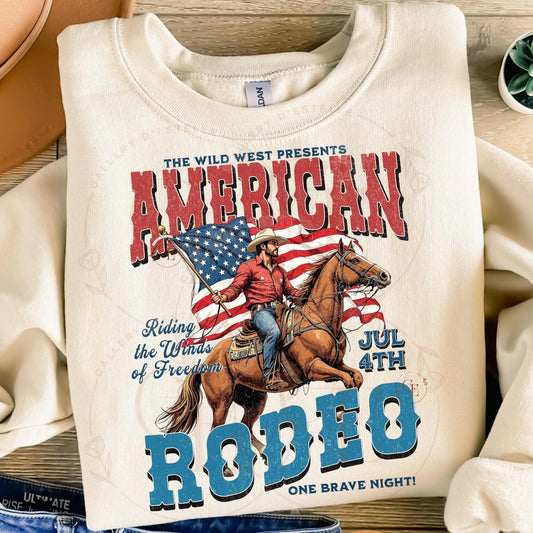 Folded white sweatshirt with American Rodeo graphic featuring a cowboy and American flag.