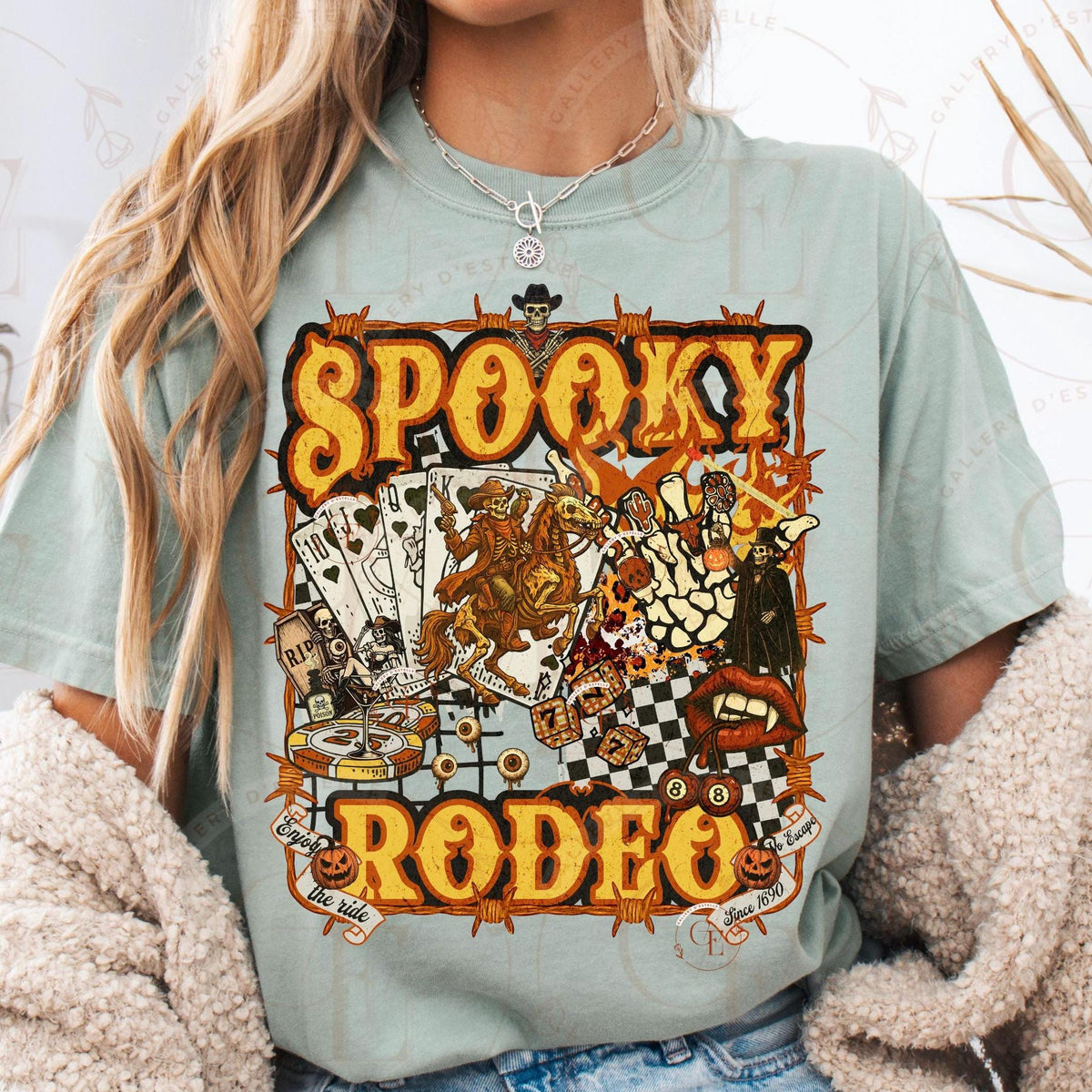 Person wearing a light blue t-shirt with 'Spooky Rodeo' graphic design.