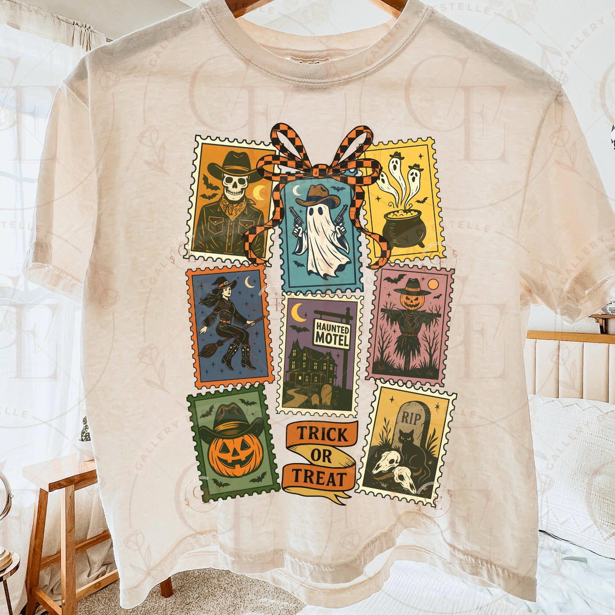 Beige t-shirt with Halloween-themed postage stamp designs on a white background.