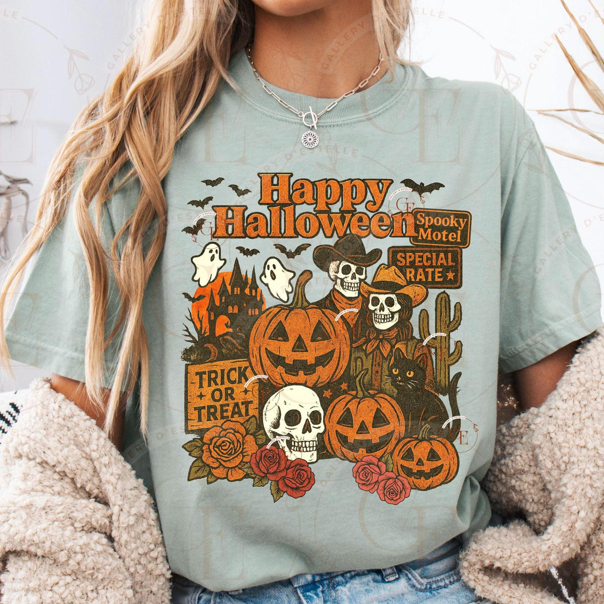 Person wearing a light blue t-shirt with Halloween-themed graphics