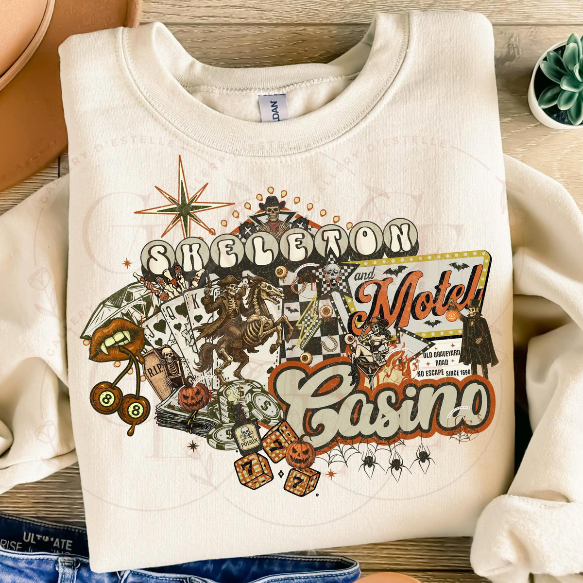 White sweatshirt with Halloween-themed design featuring text and graphics on a wooden surface.