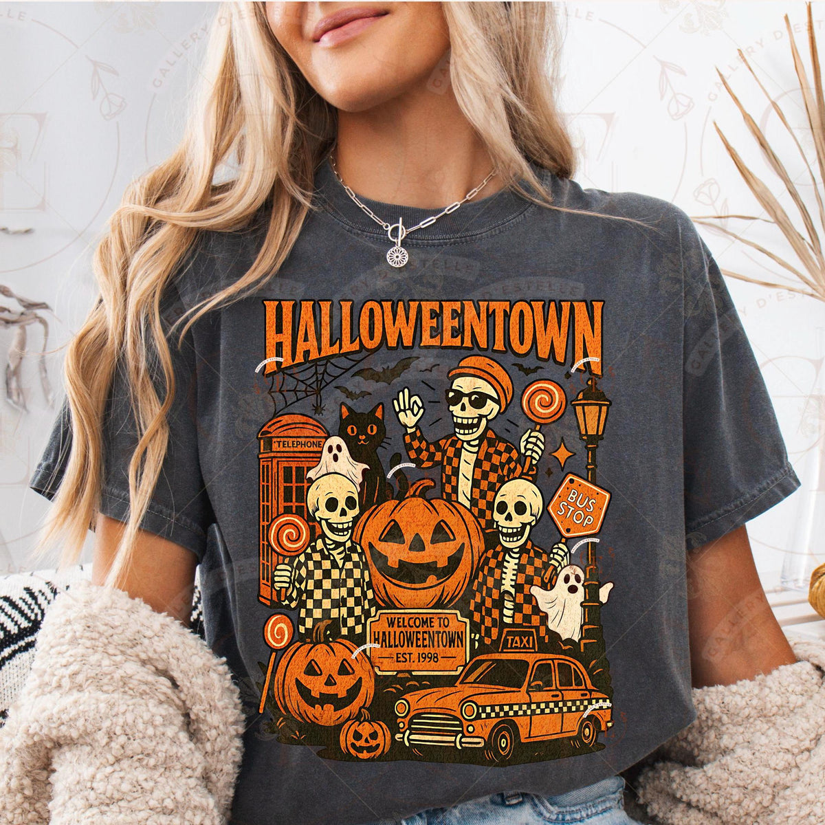 Person wearing a 'Halloweentown' themed t-shirt with Halloween graphics.