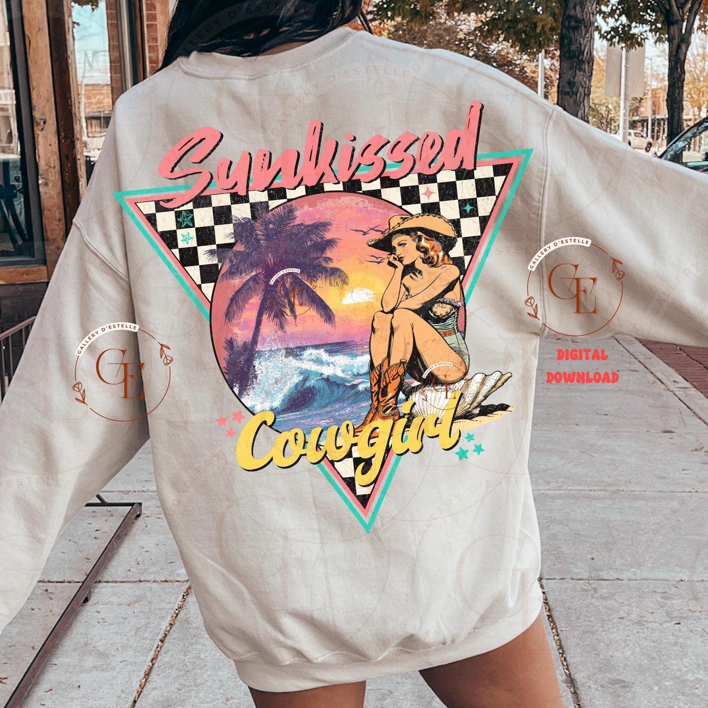 Person wearing a light beige sweatshirt with a retro coastal cowgirl design with checkered backdrop and sunset vibes and the quote " Sunkissed Cowgirl"
