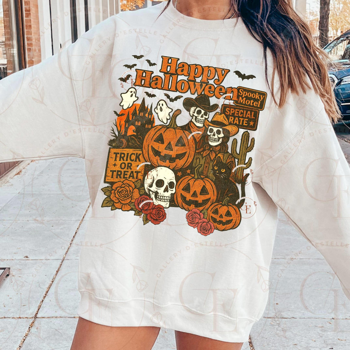 Person wearing a white sweatshirt with Halloween-themed graphics.